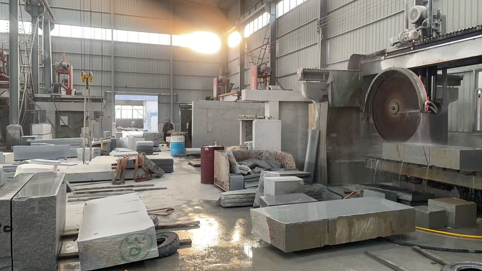 Stone cutting equipment and granite components inside the workshop